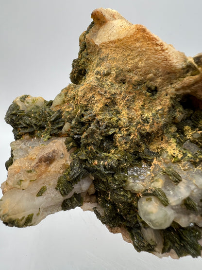 Epidote And Quartz Specimen. Stunning Quartz Cluster With Peach Inclusions Covered In Epidote.