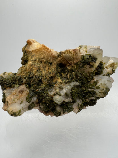 Epidote And Quartz Specimen. Stunning Quartz Cluster With Peach Inclusions Covered In Epidote.