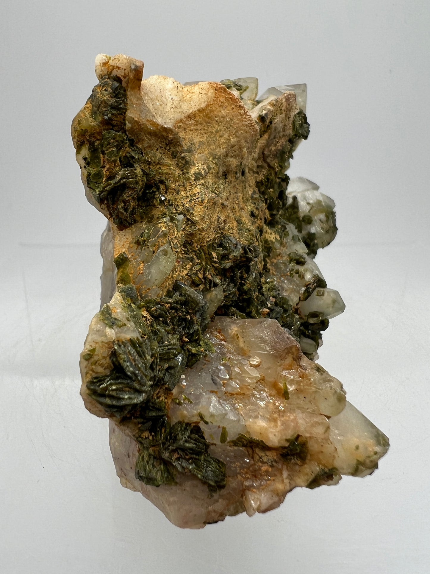 Epidote And Quartz Specimen. Stunning Quartz Cluster With Peach Inclusions Covered In Epidote.