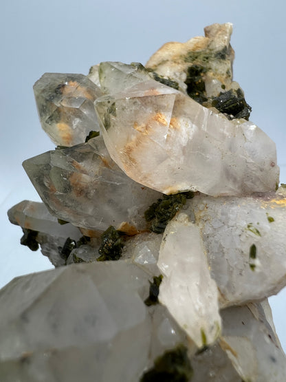 Epidote And Quartz Specimen. Stunning Quartz Cluster With Peach Inclusions Covered In Epidote.